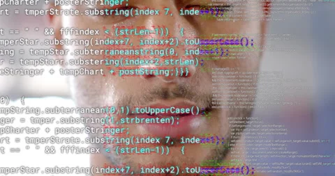 Male developer focusing on code stream, glitching JavaScript overlay across face Stock Footage 314737549