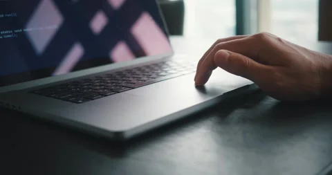 Male developer hands scroll and swipe on laptop touchpad looking at the written Stock Footage 249458068
