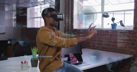 Male developer putting on VR headset in tech office, raising UI aligning with 動画素材 334034837