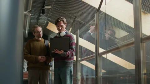 Male Developer Showing New Software on Laptop to His Colleague Video stock 319996849