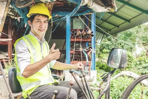 Male developer sitting operator driving excavator at construction site. Stock Photos