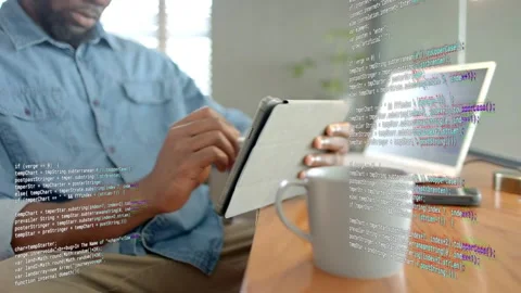 Male developer tapping tablet with stylus activating code overlay grabbing Stock Footage 333078382