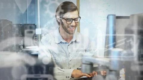 Male developer typing at keyboard, activating HUD data overlays, reviewing Stock Footage 326973980