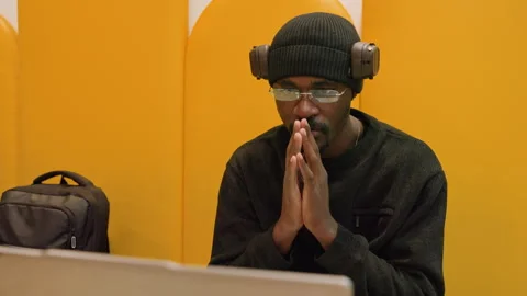 Male developer under pressure during urgent online discussion. Black male Video stock 338286565