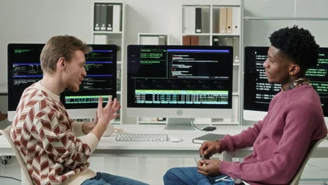 Male Developers Discussing Code on Screen then Giving Dap at Computer Desk 動画素材 330128643