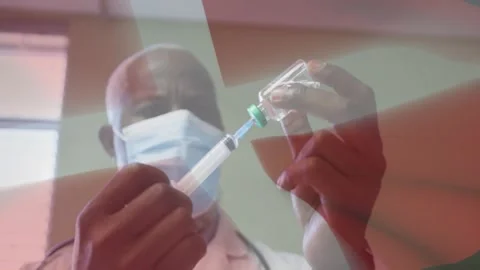 Male doc aligning needle to vial, drawing dose, prepping syringe for injection Stock Footage 329550920