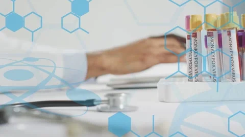 Male doc typing on keyboard and logging monkeypox tubes, stethoscope near, blue Stock Footage 334883997