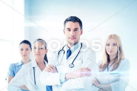 Male Doctor In Front Of Medical Group