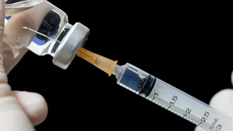 Male doctor preparing a syringe for injection Nurse or doctor with a 2 ml Stock-Footage 336586953