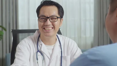Male Doctor Smiling To Camera While Talking To A Fat Male Patient In Clinic Stock Footage 249607931