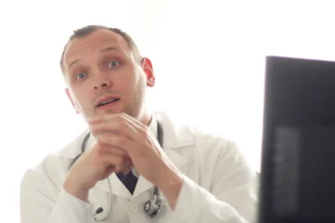 Male doctor talking to the camera NTSC Stock Footage
