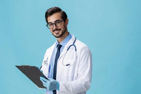 Male doctor in a white coat and glasses with a medical record and a stethoscope Stock Photos