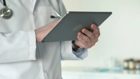 Male doctors hands using tablet Stock Footage 168458210