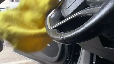 Male Doing Car Detailing On Driver Side Of Car Wiping Down Steering Wheel And Do Video stock 210960786