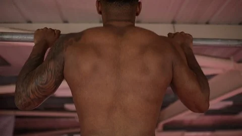 Male doing pull ups in a boxing gym Stock Footage 73391648