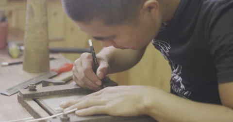 Male draws marking on object on table Stock Footage 141362711