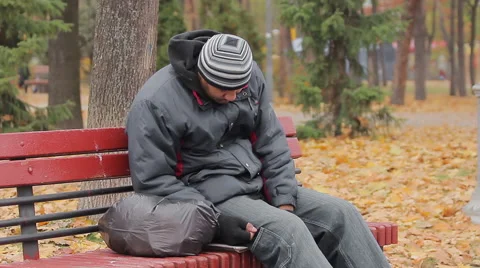 Male drinking addict sleeping on bench in autumn park, alcohol abuse problem Stock Footage 63017223