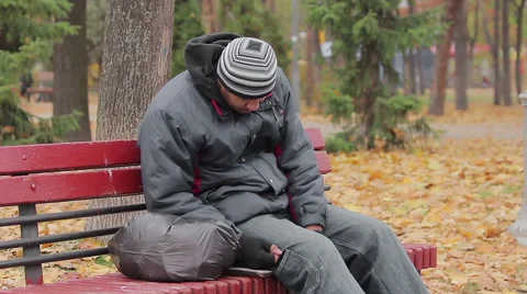 Male drinking addict sleeping on bench in autumn park, alcohol abuse problem Stock Footage 63024906
