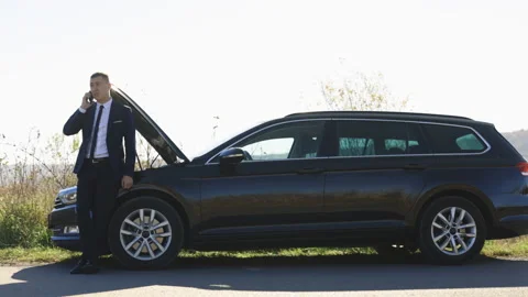 Male driver calling someone for help during problems on road. Mature business Stock Footage 194753728