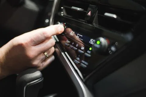 Male driver controls the settings of his car with buttons Stock Photos