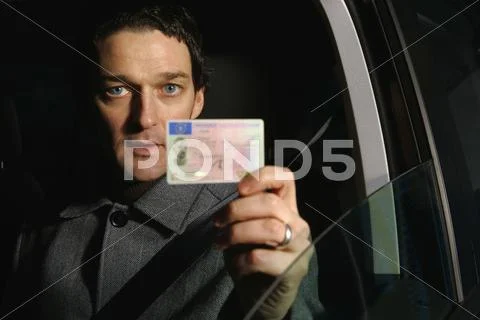 Male Driver Holding His Id Card