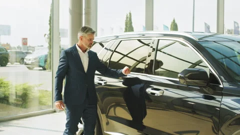 Male driver opening door while look the interior of his new auto. Seriously Stock Footage 240227046