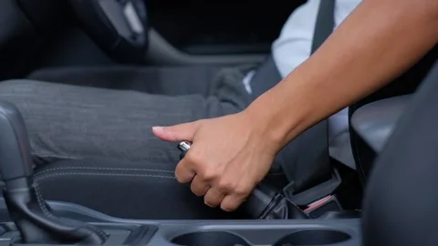 The male driver pulls the handbrake when parking Stock Footage 133346737