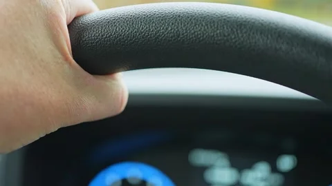 Male driver put hand on the steering wheel of a car macro close up. Shallow.. Stock Footage 293844813