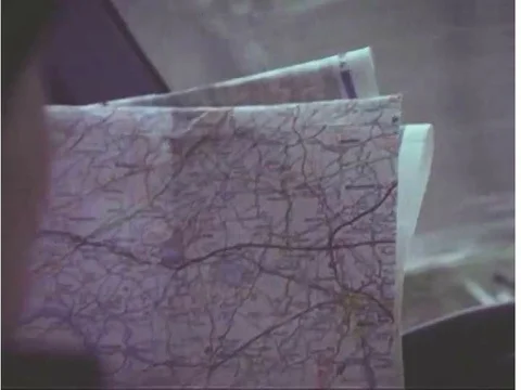 A male driver, reading a map, driving a car with bare tires, crashes into a Stock Footage 74948306