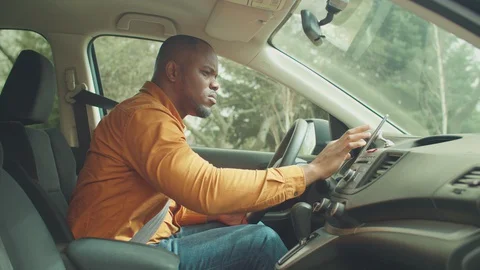 Male driver using smartphone for gps navigation in car Stock Footage 129152250
