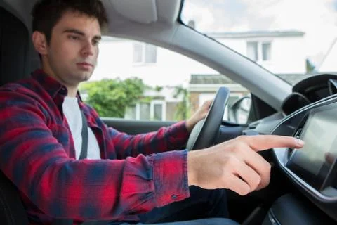 Male Driver Using Touchscreen In Car Stock Photos