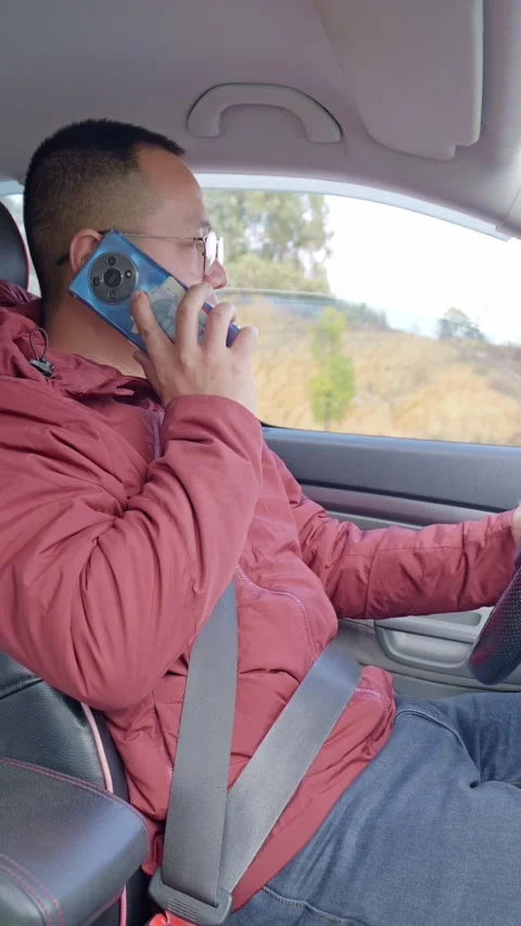 A male driver’s taking a call while driving. Stock Footage 329167969