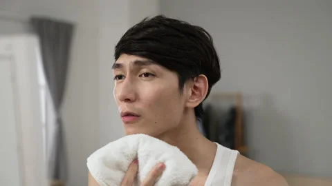 Male is drying face with a towel Stock Footage 199081859