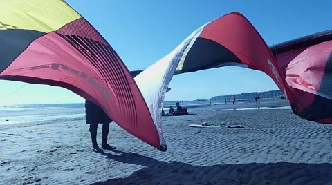 Male drying up kite on beach Stock Footage 62810554