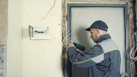 Male electrician performs installation work Stock Footage 99695176
