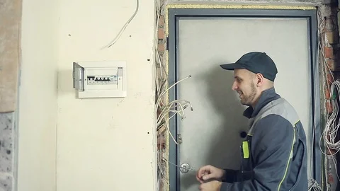 Male electrician performs installation work Stock Footage 99695429
