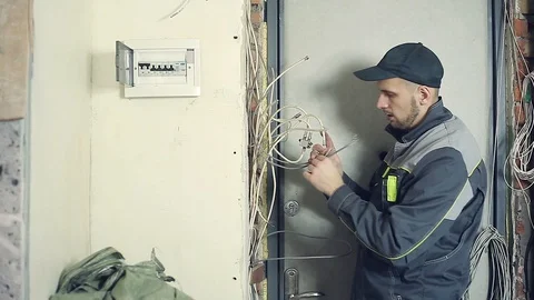Male electrician performs installation work Stock Footage 99696733