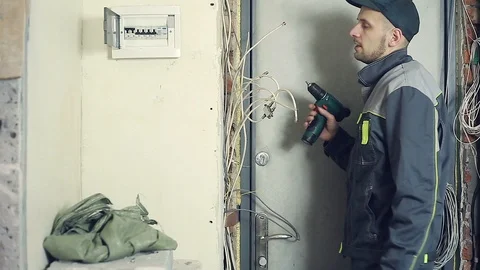 Male electrician performs installation work Stock Footage 99697767
