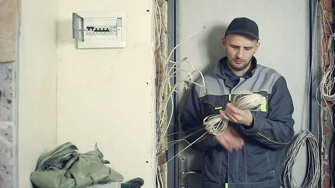 Male electrician performs installation work Stock Footage 99698941
