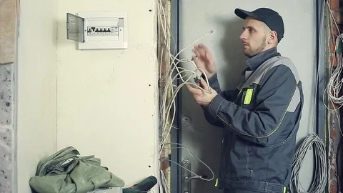Male electrician performs installation work Stock Footage 99700574