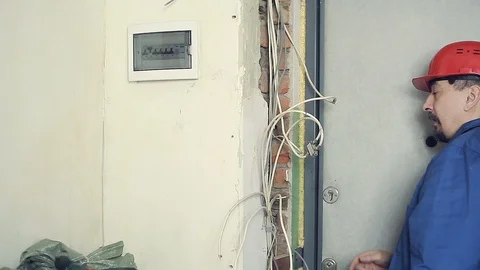 Male electrician performs installation work Stock Footage 99702142