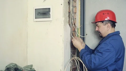 Male electrician performs installation work Stock Footage 99702337