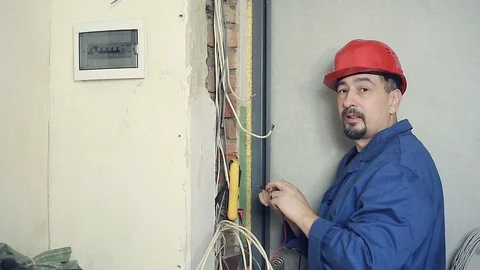 Male electrician performs installation work Stock Footage 99702533