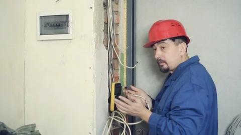 Male electrician performs installation work Stock Footage 99703088