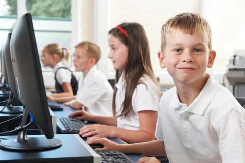 Male elementary pupil in computer class Stock Photos