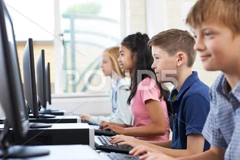 Male Elementary Pupil In Computer Class Stock Photos
