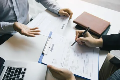 Male employee is explaining to the manager while being interviewed in the o.. Stock Photos