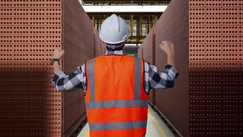 A Male Engineer Celebrating While Working With Brick In Stacks Stock Footage 303760083