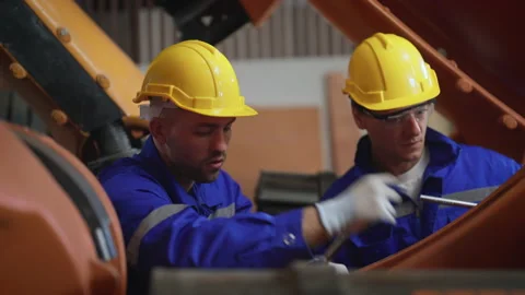 Male engineer checking and fixing robot arm in Advanced Manufacturing Facility. Stock Footage 239507471