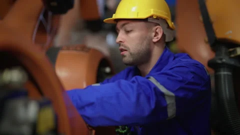 Male engineer checking and fixing robot arm. Stock Footage 239507582